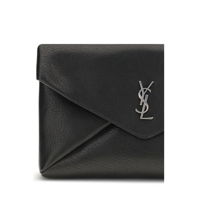 Black Calf Leather Bos Taurus Clutch BagThe Cassandre Large Envelope Clutch Bag by Saint Laurent is an elegant design with a front flap embellished with a silver logo. The magnetic snap-button closure ensures practicality, while the interior features a fl