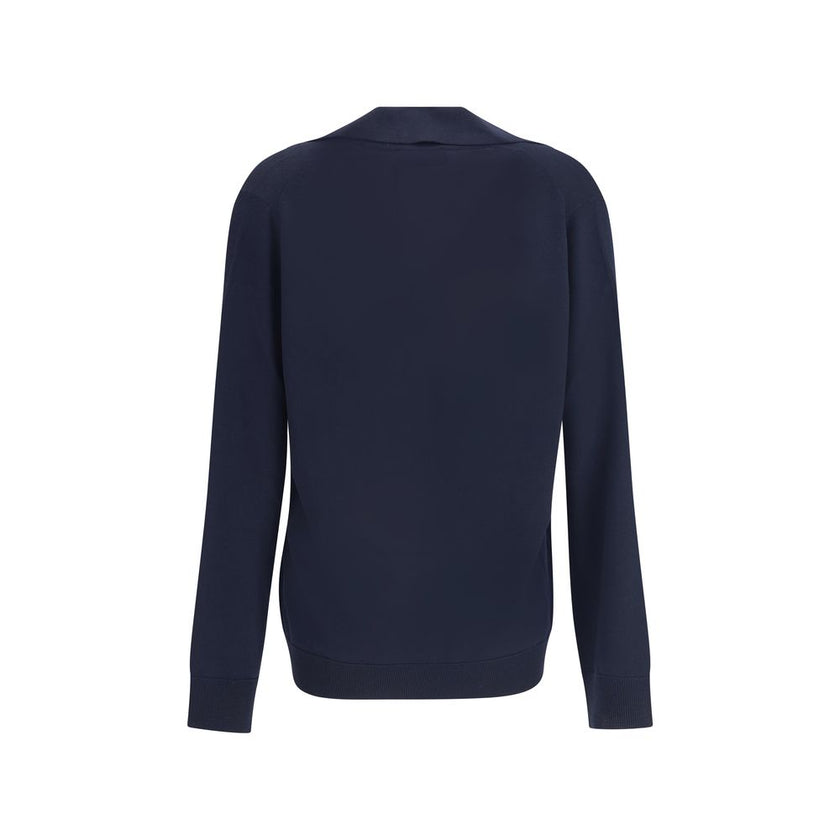 Blue Wool SweatshirtThe Gucci polo Sweater combines relaxed elegance and iconic details. Crafted with a relaxed fit, it features a classic collar and a deep V-neckline that enhance its casual-chic silhouette. The design is completed by long sleeves, ribbe