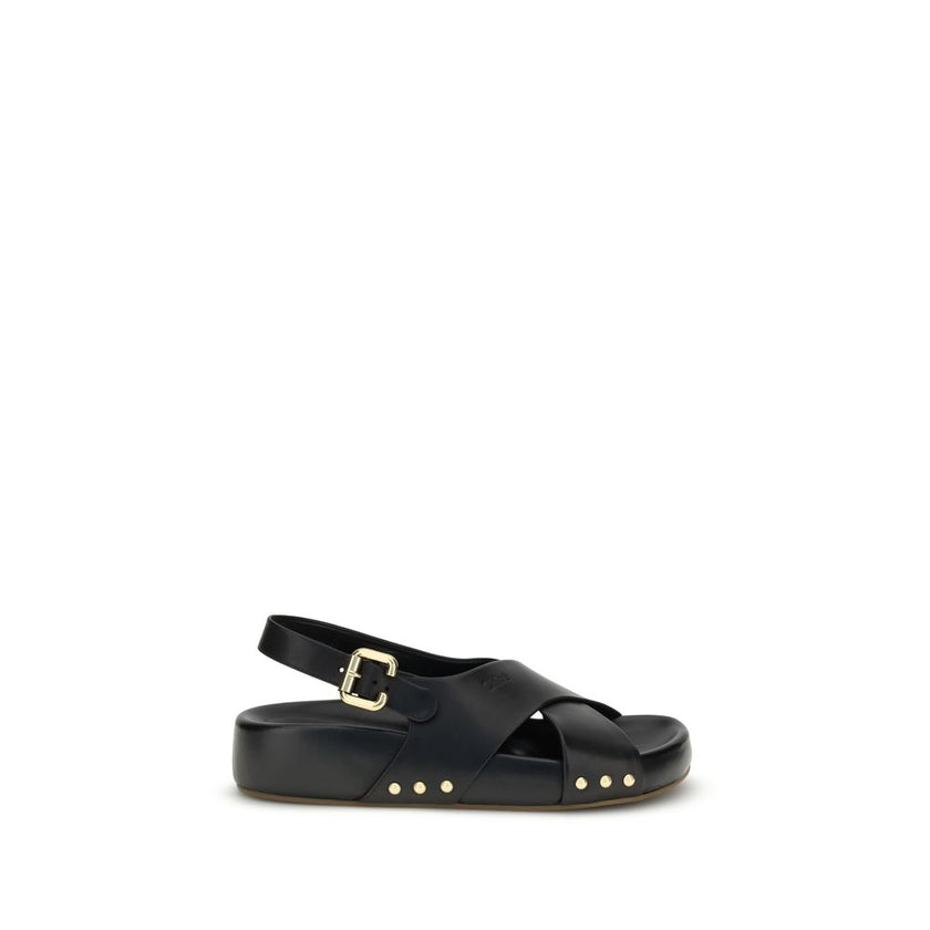 Mae SandalsThe Mae Sandals by Chloé, crafted from smooth calfskin, combine elegance and comfort thanks to the anatomical insole designed to last all day. The upper is characterized by crossed straps and an adjustable ankle strap, secured by the iconic Pad