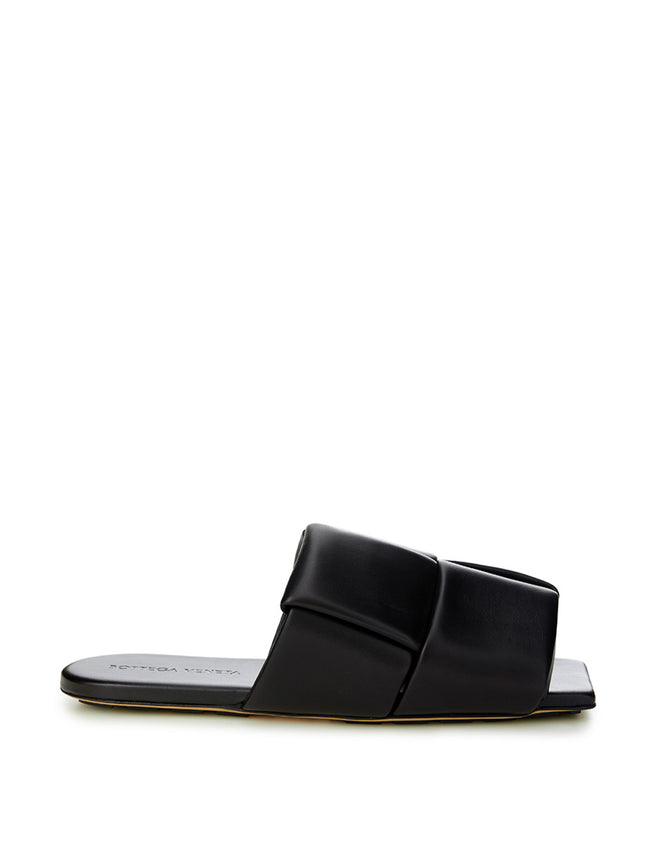 Elegant Black Leather SandalsStep into luxurious simplicity with these elegantly crafted black leather sandals by Bottega Veneta. Perfect for any occasion, they seamlessly blend high-end craftsmanship with sleek design, embodying Italian sophistication. I