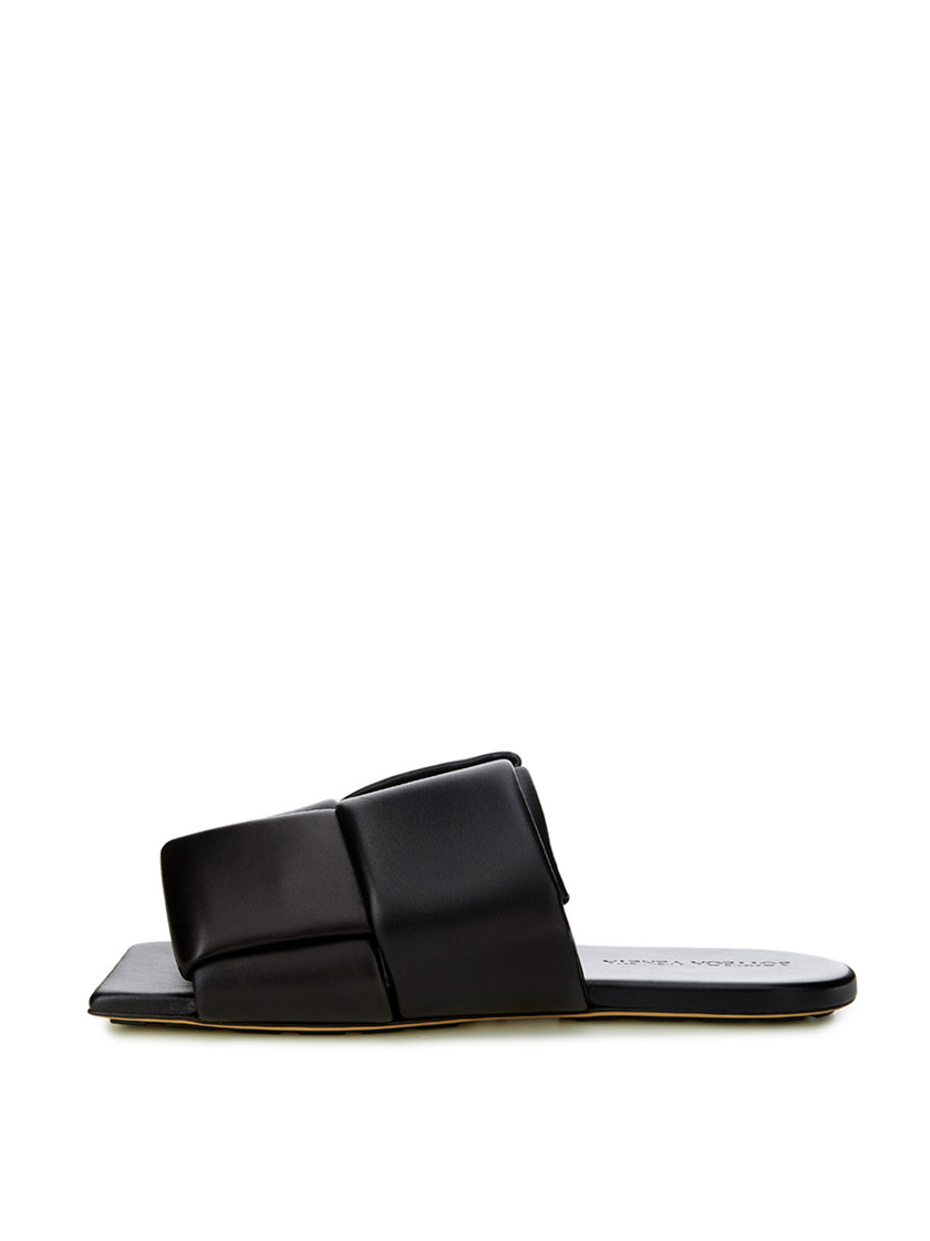 Elegant Black Leather SandalsStep into luxurious simplicity with these elegantly crafted black leather sandals by Bottega Veneta. Perfect for any occasion, they seamlessly blend high-end craftsmanship with sleek design, embodying Italian sophistication. I