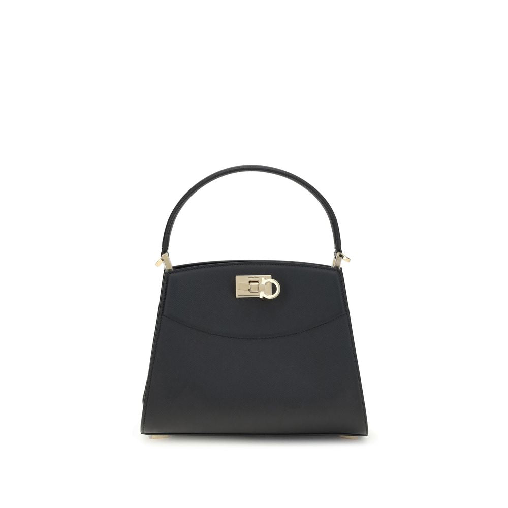 Black Calf Leather Bos Taurus HandbagFerragamo’s Studio Box Bag combines structured elegance and iconic details of the Maison. With trapezoid lines and a ladylike allure, it is embellished with rounded stitching on the front and the Gancini slider closure