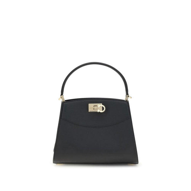 Black Calf Leather Bos Taurus HandbagFerragamo’s Studio Box Bag combines structured elegance and iconic details of the Maison. With trapezoid lines and a ladylike allure, it is embellished with rounded stitching on the front and the Gancini slider closure