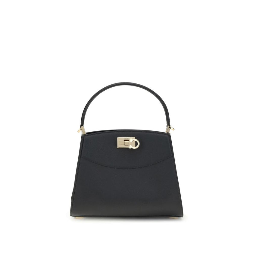Black Calf Leather Bos Taurus HandbagFerragamo’s Studio Box Bag combines structured elegance and iconic details of the Maison. With trapezoid lines and a ladylike allure, it is embellished with rounded stitching on the front and the Gancini slider closure
