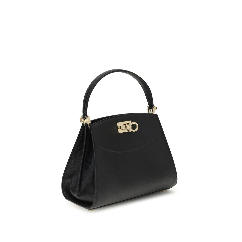 Black Calf Leather Bos Taurus HandbagFerragamo’s Studio Box Bag combines structured elegance and iconic details of the Maison. With trapezoid lines and a ladylike allure, it is embellished with rounded stitching on the front and the Gancini slider closure
