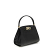 Black Calf Leather Bos Taurus HandbagFerragamo’s Studio Box Bag combines structured elegance and iconic details of the Maison. With trapezoid lines and a ladylike allure, it is embellished with rounded stitching on the front and the Gancini slider closure