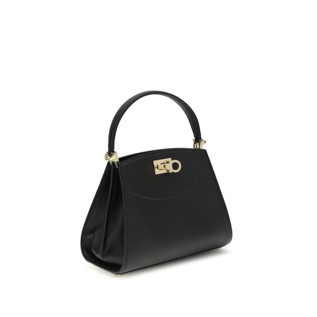 Black Calf Leather Bos Taurus HandbagFerragamo’s Studio Box Bag combines structured elegance and iconic details of the Maison. With trapezoid lines and a ladylike allure, it is embellished with rounded stitching on the front and the Gancini slider closure
