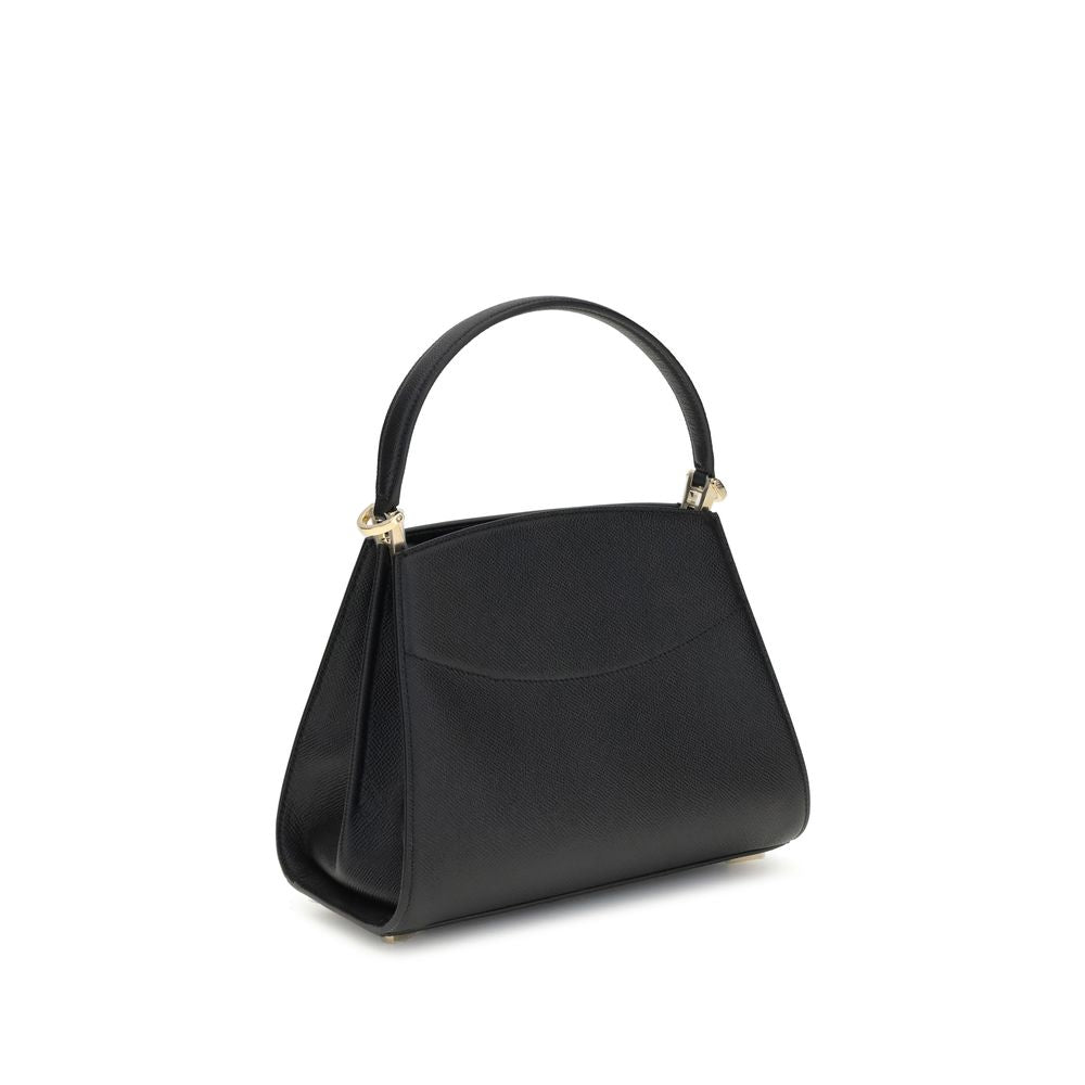 Black Calf Leather Bos Taurus HandbagFerragamo’s Studio Box Bag combines structured elegance and iconic details of the Maison. With trapezoid lines and a ladylike allure, it is embellished with rounded stitching on the front and the Gancini slider closure