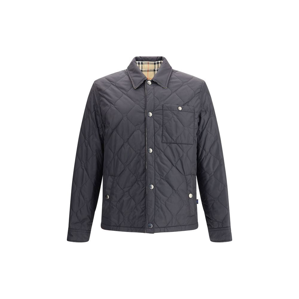 Reversible quilted nylon JacketBurberry’s reversible quilted nylon Jacket combines functionality and distinctive style in one versatile piece. One side features a solid-color quilted nylon fabric, while the other features the classic Burberry Check patter
