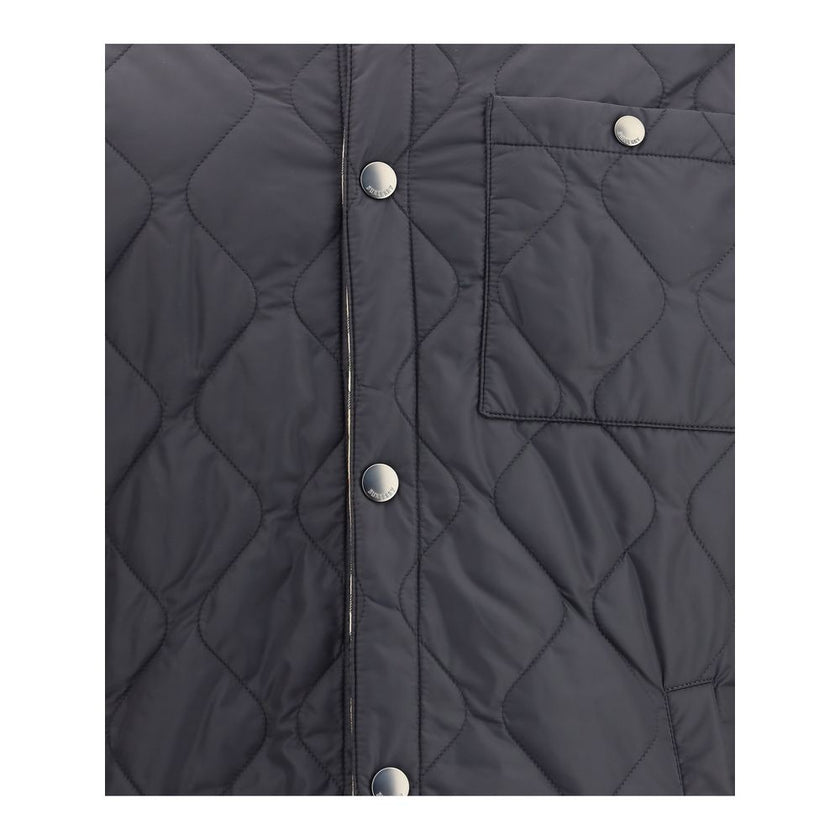 Reversible quilted nylon JacketBurberry’s reversible quilted nylon Jacket combines functionality and distinctive style in one versatile piece. One side features a solid-color quilted nylon fabric, while the other features the classic Burberry Check patter