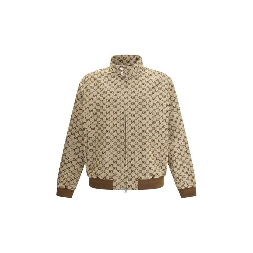 Beige Cotton Shell JacketGucci’s GG Supreme Jacket features a sporty, iconic design with a high collar fastened with snap buttons and a front zipper closure. Two side welt pockets, ribbed hem and cuffs complete the design for a comfortable fit and distinc