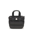 Black Polyamide HandbagThe Moncler Caradoc mini Tote Bag combines functionality and contemporary style. Crafted from water-repellent nylon, it features a perforated nylon lining and down padding for lightweight protection. Ribbon handles with leather grip