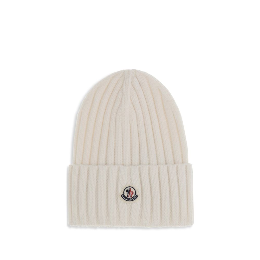 Wool beanie HatMoncler’s wool beanie Hat combines functionality and style in a ribbed design with a modern character. Soft and warm, it is ideal for facing cold days with comfort and personality. A stitched ion logo patch stands out on the front, giving i