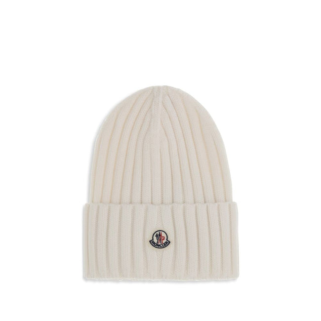 Wool beanie HatMoncler’s wool beanie Hat combines functionality and style in a ribbed design with a modern character. Soft and warm, it is ideal for facing cold days with comfort and personality. A stitched ion logo patch stands out on the front, giving i