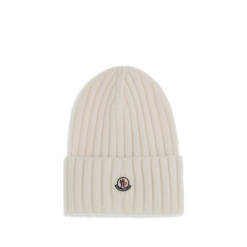 Wool beanie HatMoncler’s wool beanie Hat combines functionality and style in a ribbed design with a modern character. Soft and warm, it is ideal for facing cold days with comfort and personality. A stitched ion logo patch stands out on the front, giving i