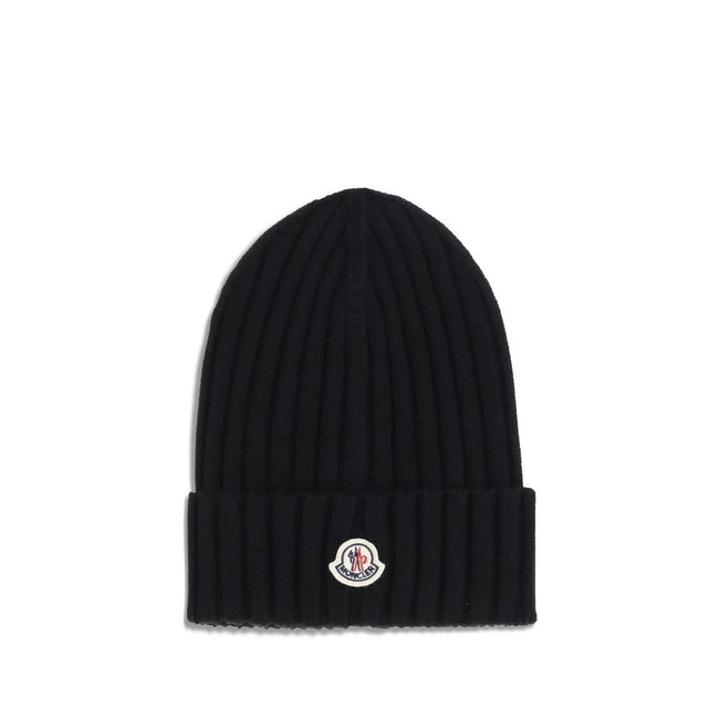 Wool beanie HatMoncler’s wool beanie Hat combines functionality and style in a ribbed design with a modern character. Soft and warm, it is ideal for facing cold days with comfort and personality. A stitched ion logo patch stands out on the front, giving i