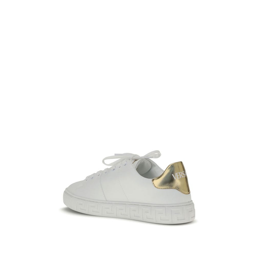 White Calf Leather Bos Taurus Low Top SneakersThe Versace Medusa Sneakers stand out for their iconic Greek key sole and gold heel embellished with the brand’s logo. Featuring a rounded toe and lace-up closure, they also feature an elegant gold Medusa deta