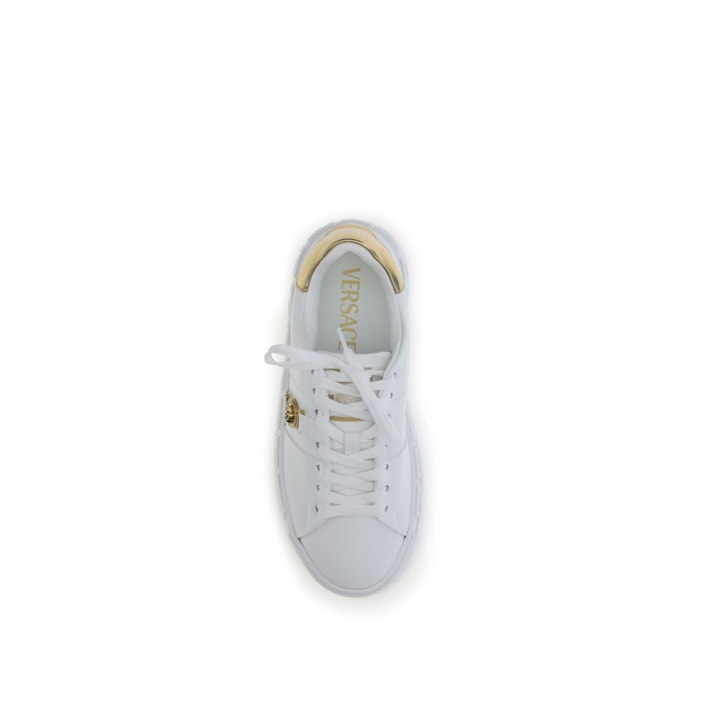 White Calf Leather Bos Taurus Low Top SneakersThe Versace Medusa Sneakers stand out for their iconic Greek key sole and gold heel embellished with the brand’s logo. Featuring a rounded toe and lace-up closure, they also feature an elegant gold Medusa deta