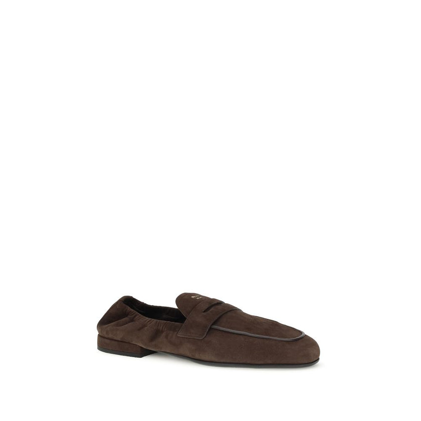 Brown Lamb Ovis Aries Aries Slip-On LoafersPrada’s Shuffle Loafers are made of suede and feature a sleek and contemporary leather horsebit upper. The screen-printed logo adds a refined touch, while the rubber sole with branded logo combines style and func