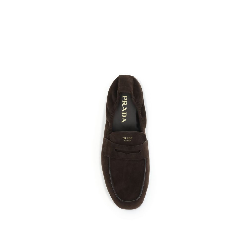 Brown Lamb Ovis Aries Aries Slip-On LoafersPrada’s Shuffle Loafers are made of suede and feature a sleek and contemporary leather horsebit upper. The screen-printed logo adds a refined touch, while the rubber sole with branded logo combines style and func