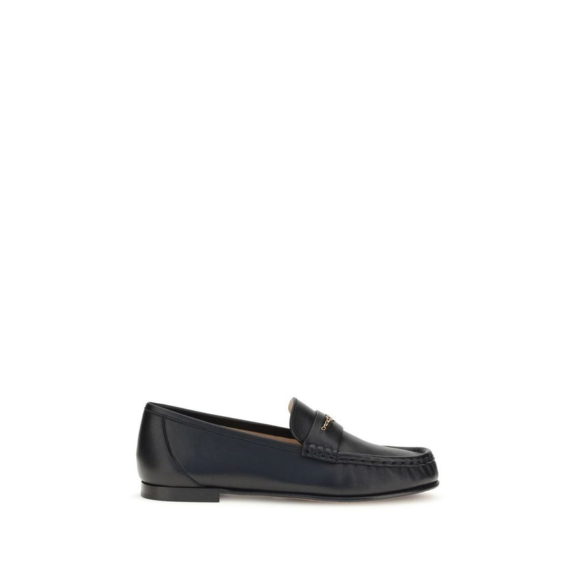 Black Calf Leather Bos Taurus Slip-On LoafersLeather Loafers by Chloé are crafted from fine polished calfskin and feature an elegant silhouette with refined pleated details. The upper is embellished with a subtle gold chain with the Chloé logo, lending a