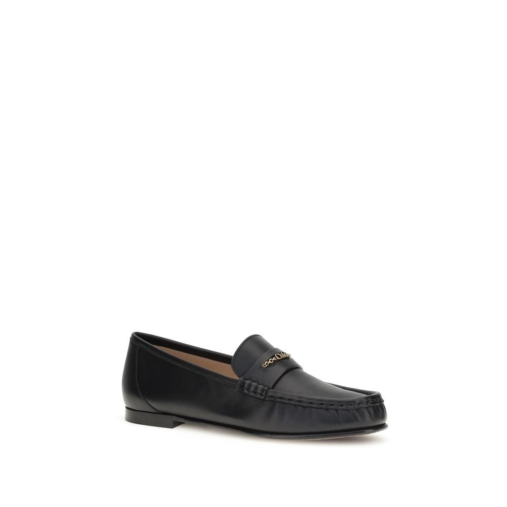 Schwarze Leder-Slipper mit goldener Kettenapplikation