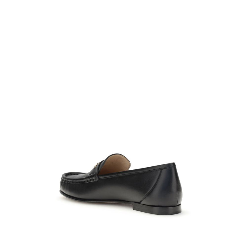 Black Calf Leather Bos Taurus Slip-On LoafersLeather Loafers by Chloé are crafted from fine polished calfskin and feature an elegant silhouette with refined pleated details. The upper is embellished with a subtle gold chain with the Chloé logo, lending a