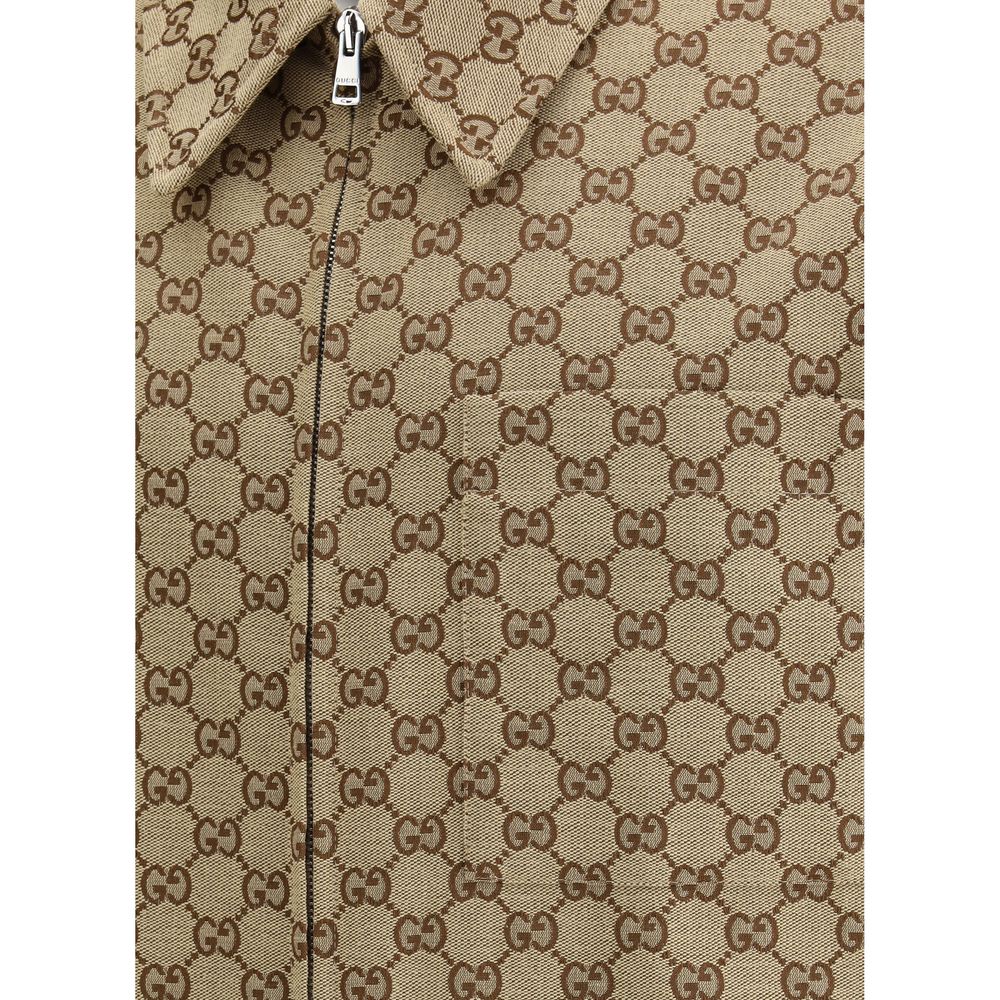 Brown Cotton Jackets And CoatThe Gucci cotton Jacket is a refined and modern piece, perfect for a casual-chic look. The shirt style offers a versatile fit, while the classic collar adds a touch of elegance. The front zip closure ensures practicality and a