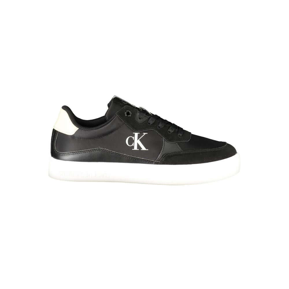 Black Leather Men SneakerElevate your sneaker game with the sleek sophistication of Calvin Klein. These sports shoes radiate a bold charisma with their contrasting details and iconic logo print, ensuring you stride with confidence. Crafted for the modern