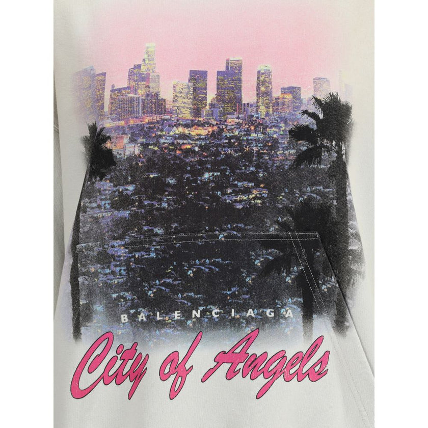 White Cotton SweatshirtBalenciaga’s City of Angels Hoodie combines comfort and urban identity in an essential yet striking design. Made of dry fleece, it features sloping shoulders, front pouch pocket and gathered trim on cuffs and waist. The drawstring-f