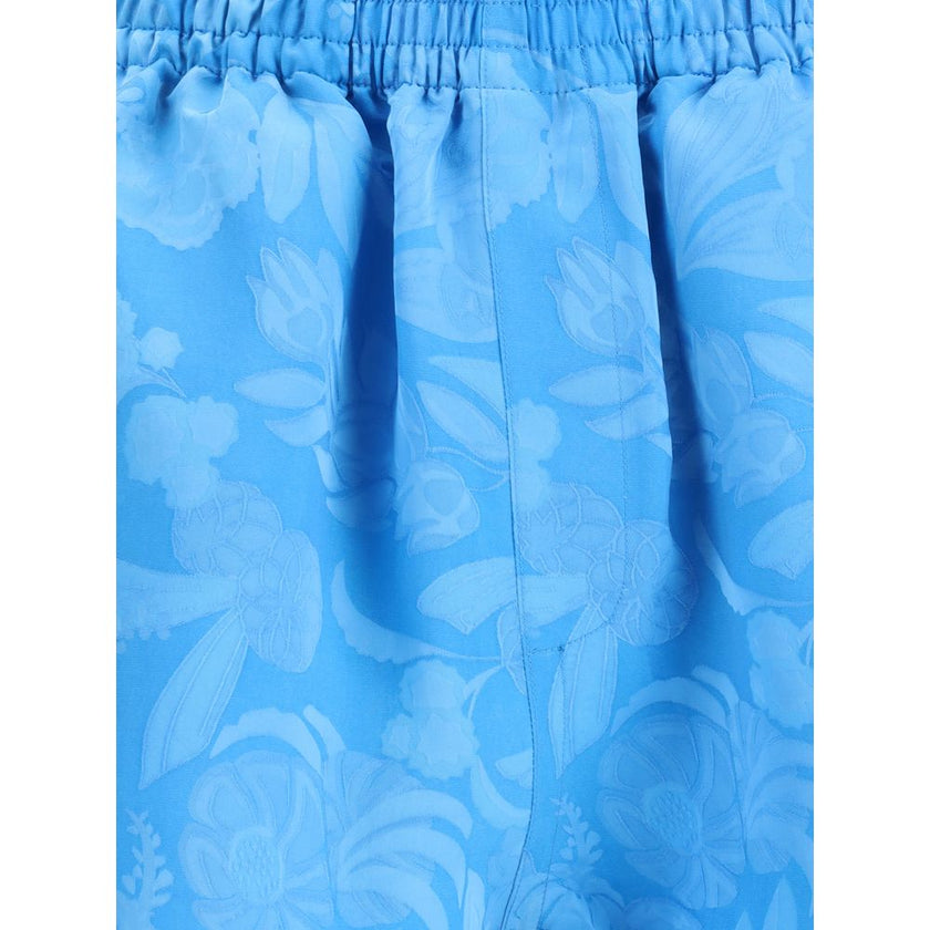 Blue Viscose Bermuda ShortsBalenciaga’s Floral patterned Shorts combine comfort and style in a soft, relaxed design. Featuring an elasticized waistband and two side welt pockets, they have a casual silhouette enhanced by a vibrant floral print, perfect fo