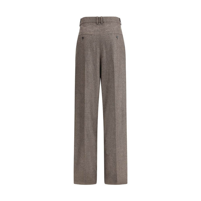 Wool Herringbone pattern wide leg PantsSaint Laurent’s wool Herringbone pattern wide leg Pants are an example of impeccable tailoring and timeless style. Featuring a medium waist and wide leg, they feature double pleats and a center crease that define an