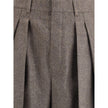 Wool Herringbone pattern wide leg PantsSaint Laurent’s wool Herringbone pattern wide leg Pants are an example of impeccable tailoring and timeless style. Featuring a medium waist and wide leg, they feature double pleats and a center crease that define an