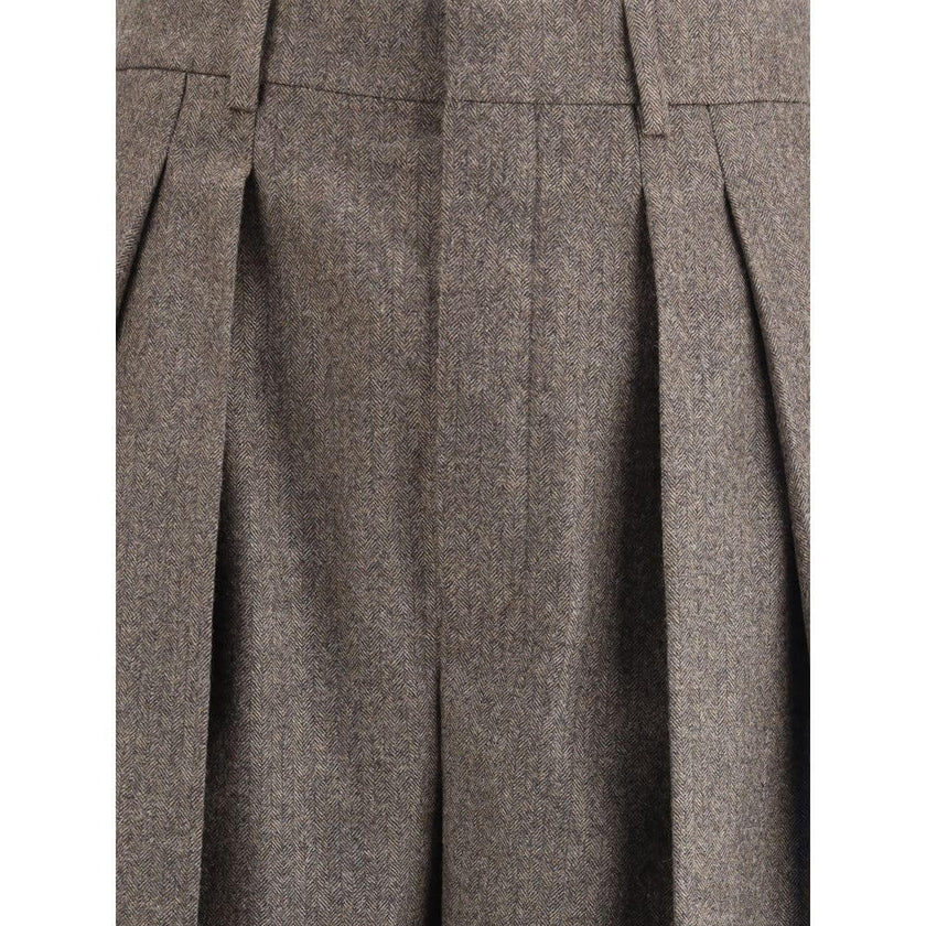 Wool Herringbone pattern wide leg PantsSaint Laurent’s wool Herringbone pattern wide leg Pants are an example of impeccable tailoring and timeless style. Featuring a medium waist and wide leg, they feature double pleats and a center crease that define an