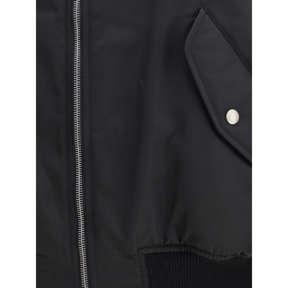 Black Polyamide BomberSaint Laurent’s oversized bomber Jacket is made of water-repellent recycled polyamide, perfect for an urban and functional look. Featuring a front zipper closure, it has two slanted flap and snap pockets, a zippered sleeve pocket and