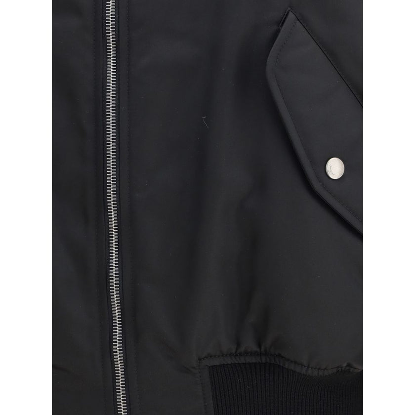 Black Polyamide BomberSaint Laurent’s oversized bomber Jacket is made of water-repellent recycled polyamide, perfect for an urban and functional look. Featuring a front zipper closure, it has two slanted flap and snap pockets, a zippered sleeve pocket and