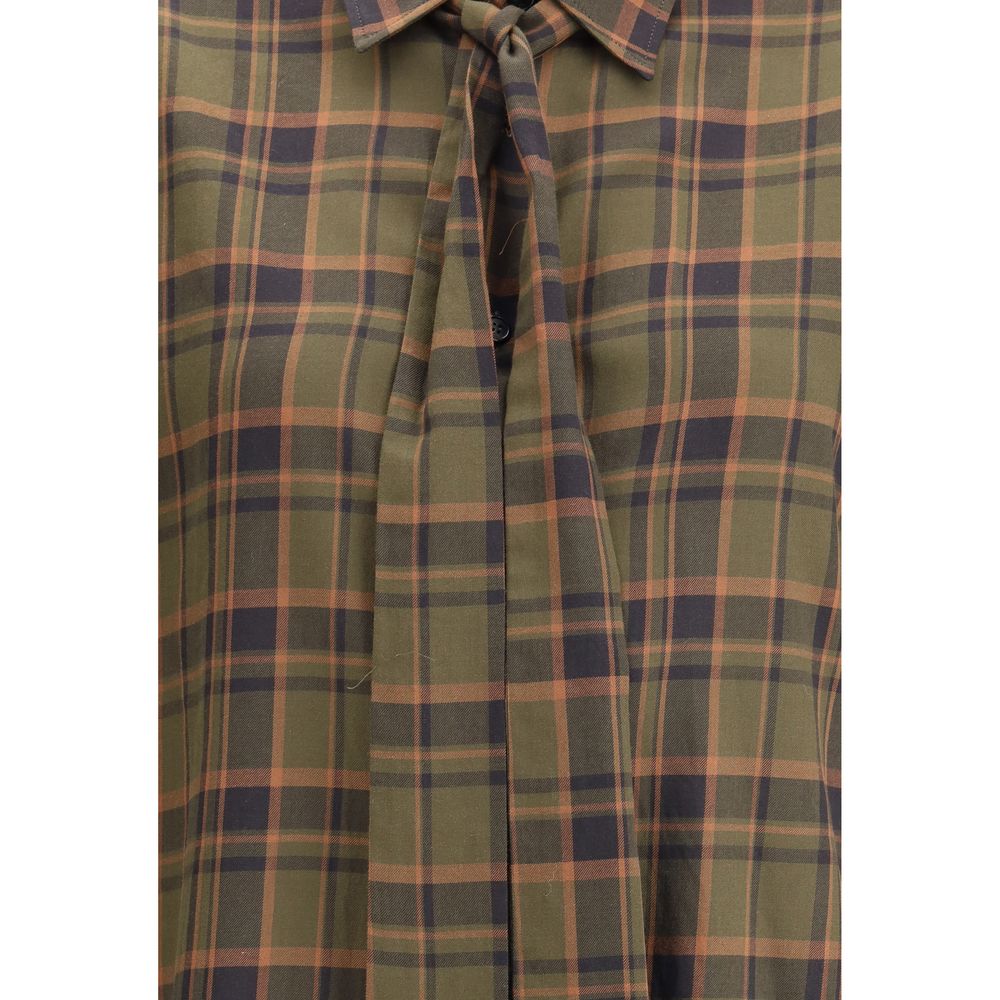 Green Cotton Pattern ShirtSaint Laurent’s Cassandre check lavallière Shirt combines retro elegance and distinctive details. Made of a check-patterned fabric, it features a front button closure, pointed collar embellished with a lavallière bow, and single-
