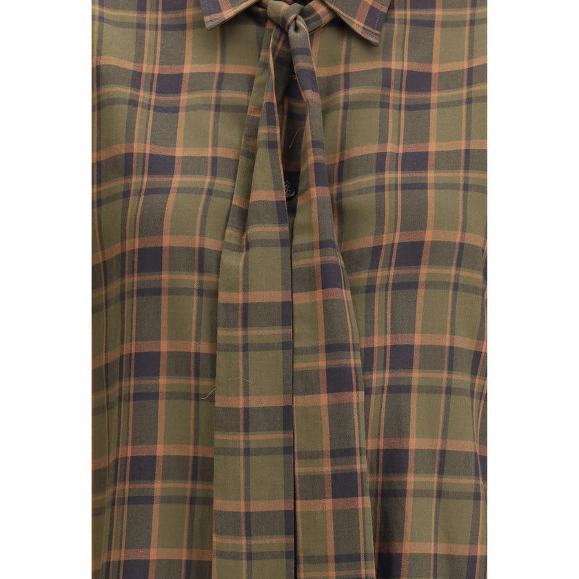 Green Cotton Pattern ShirtSaint Laurent’s Cassandre check lavallière Shirt combines retro elegance and distinctive details. Made of a check-patterned fabric, it features a front button closure, pointed collar embellished with a lavallière bow, and single-