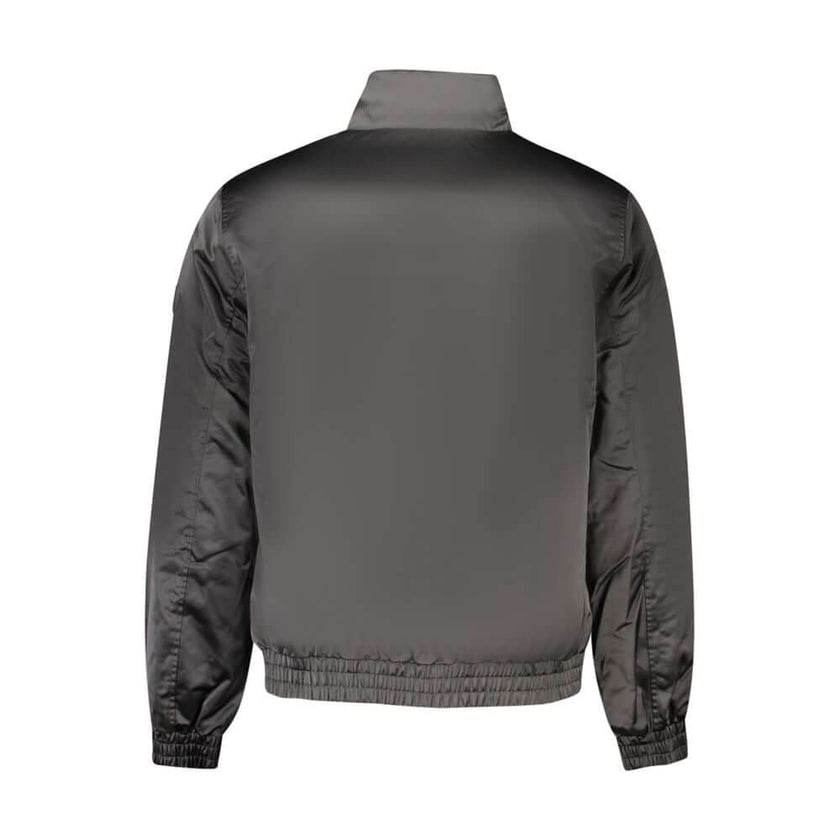 Black Polyester Men JacketStep into the epitome of both sustainability and style with this stunning Calvin Klein jacket. Crafted from 100% recycled polyester, it is as eco-conscious as it is eye-catching. With functionality at its core, the jacket offers