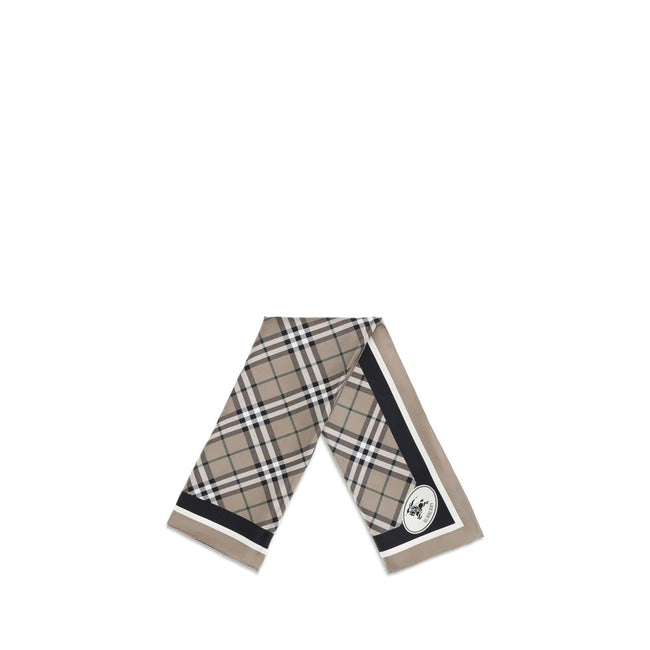 Beige Silk ScarfBurberry’s silk Scarf celebrates the house’s heritage with timeless elegance. Featuring the iconic all-over Archive Check pattern, it is embellished with the Equestrian Knight logo printed on one of the corners. Made of fine silk, it is th
