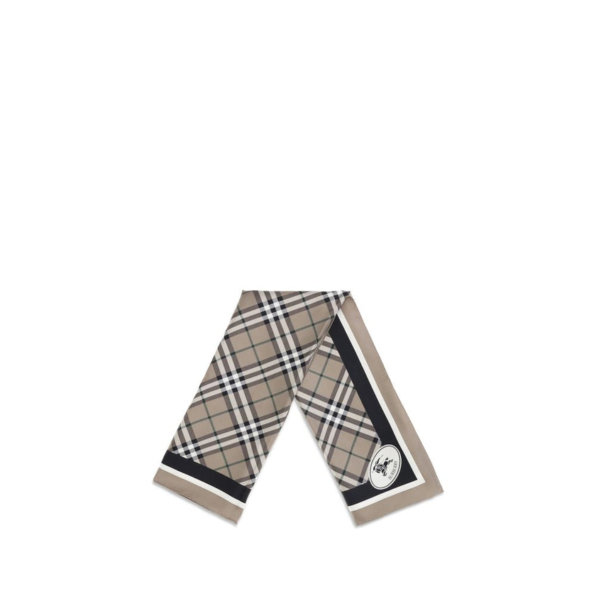 Beige Silk ScarfBurberry’s silk Scarf celebrates the house’s heritage with timeless elegance. Featuring the iconic all-over Archive Check pattern, it is embellished with the Equestrian Knight logo printed on one of the corners. Made of fine silk, it is th