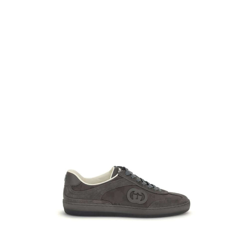 White Leather Low Top SneakersGucci’s G75 Sneakers reinterpret the retro sports aesthetic with premium materials and iconic details. Made of gray suede with GG nylon inserts, they feature a low-slung silhouette and a classic lace-up closure. The leather l
