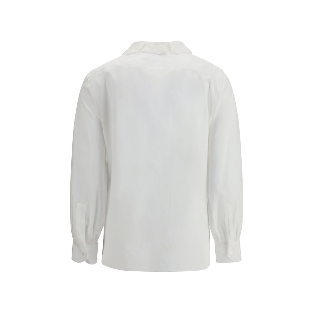 White Cotton Dress ShirtSaint Laurent’s cotton poplin Shirt combines sartorial rigor and romantic details in a sophisticated balance. Featuring a front button closure, it features a delicate Pierrot collar trimmed with lace that adds a feminine, retro tou