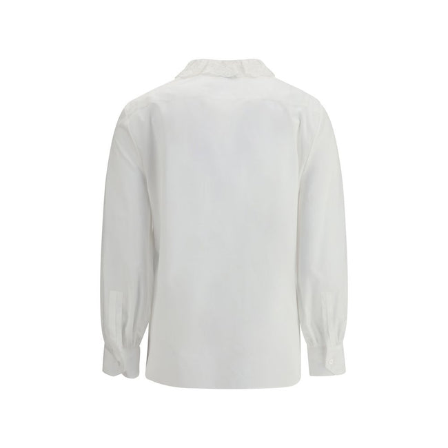 White Cotton Dress ShirtSaint Laurent’s cotton poplin Shirt combines sartorial rigor and romantic details in a sophisticated balance. Featuring a front button closure, it features a delicate Pierrot collar trimmed with lace that adds a feminine, retro tou