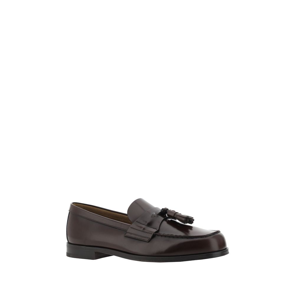 Brown Calf Leather Bos Taurus Slip-On LoafersCalfskin Loafers by Prada, slightly elongated round toe, leather block heel, front tray embellished with leather tassel, press-stamped logo insole, patent leather design. Season: AW25 Composition: 100% Calf Lea