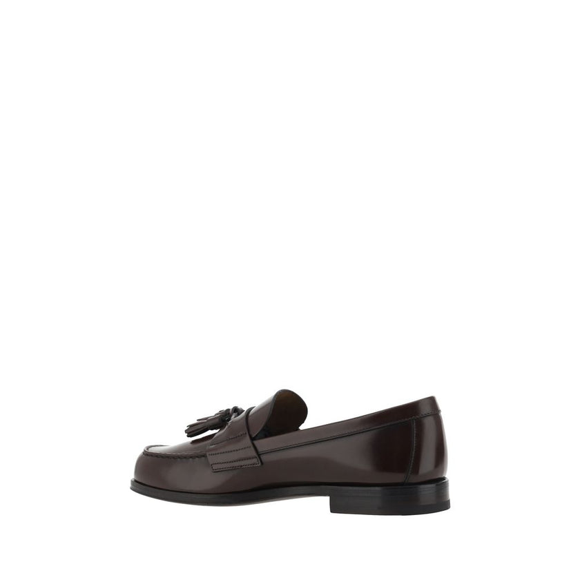 Brown Calf Leather Bos Taurus Slip-On LoafersCalfskin Loafers by Prada, slightly elongated round toe, leather block heel, front tray embellished with leather tassel, press-stamped logo insole, patent leather design. Season: AW25 Composition: 100% Calf Lea