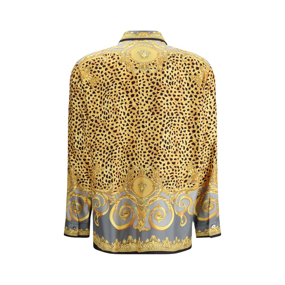 Multicolor Silk Pattern ShirtVersace’s silk Cheetah Foulard Shirt is a bold and sophisticated piece featuring a vibrant Cheetah Foulard print that combines animal motifs and baroque elements. Made from fine silk, it features long sleeves, a pointed collar