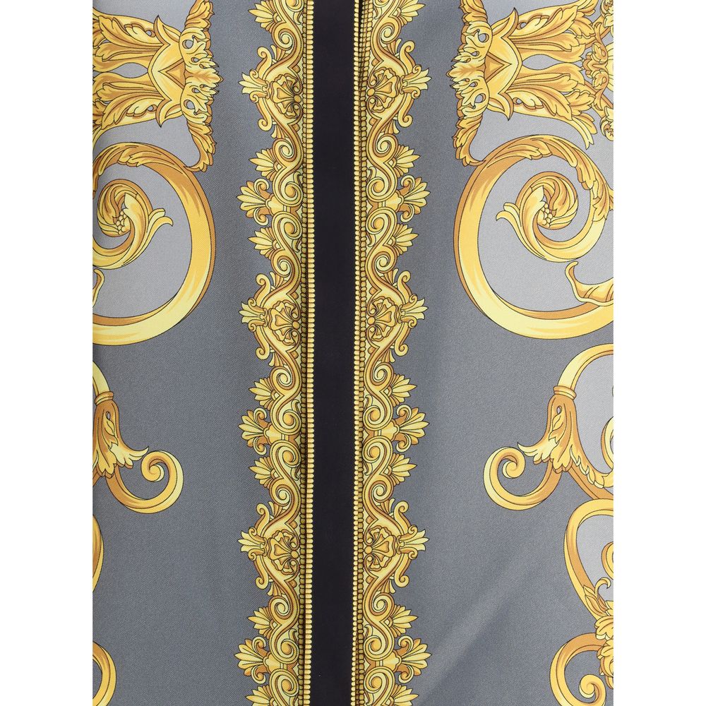 Multicolor Silk Pattern ShirtVersace’s silk Cheetah Foulard Shirt is a bold and sophisticated piece featuring a vibrant Cheetah Foulard print that combines animal motifs and baroque elements. Made from fine silk, it features long sleeves, a pointed collar