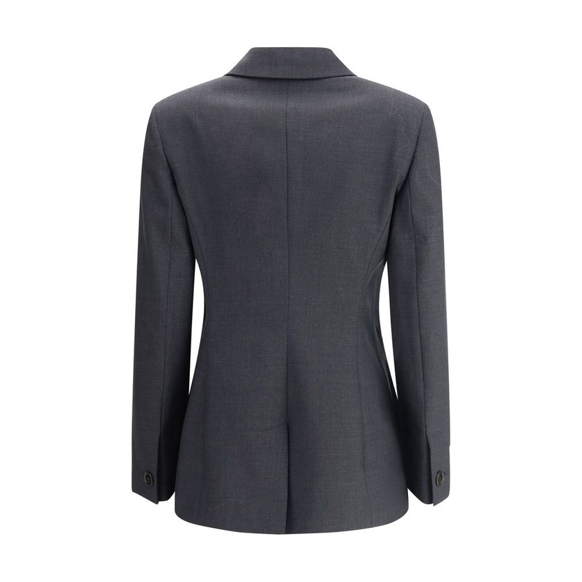 Gray Wool ClothingGucci’s wool Blazer is a classic piece with a bold style, enhanced by distinctive tailoring details. The double-breasted button closure lends structure and sophistication, while the two front welt flap pockets add functionality and symme