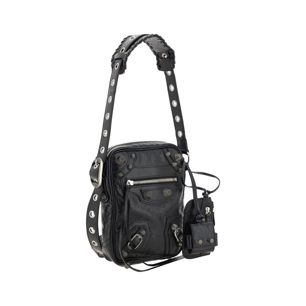 Black Lamb Ovis Aries Aries Shoulder BagLambskin Le Cagole Messenger Shoulder Bag by Balenciaga, adjustable and removable shoulder strap, all-over metallic and studded appliqué detailing, a top zip fastening, a slit pocket on the front with a zip for clos